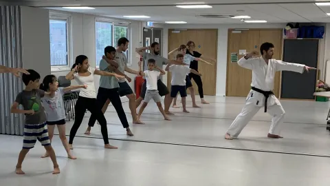 Students performing soto-uke, lead by instructor Simon Apen-Sadler